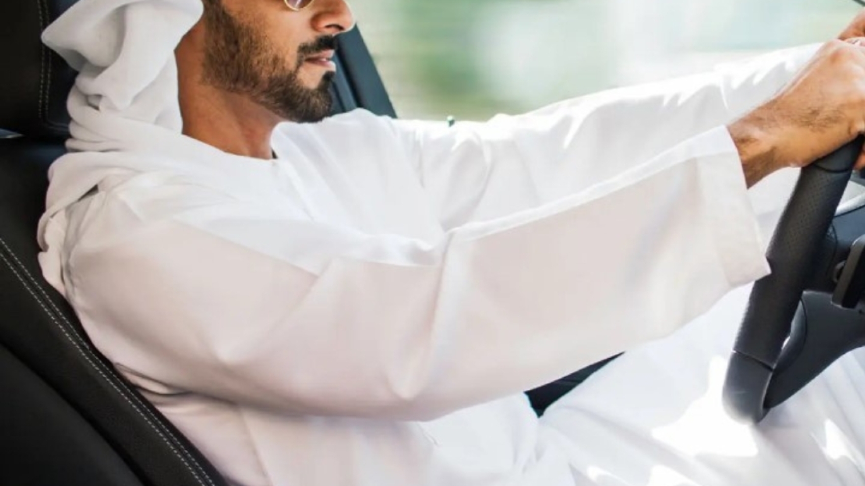 saudi arabian man driving car.