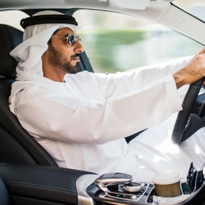 saudi arabian man driving car.